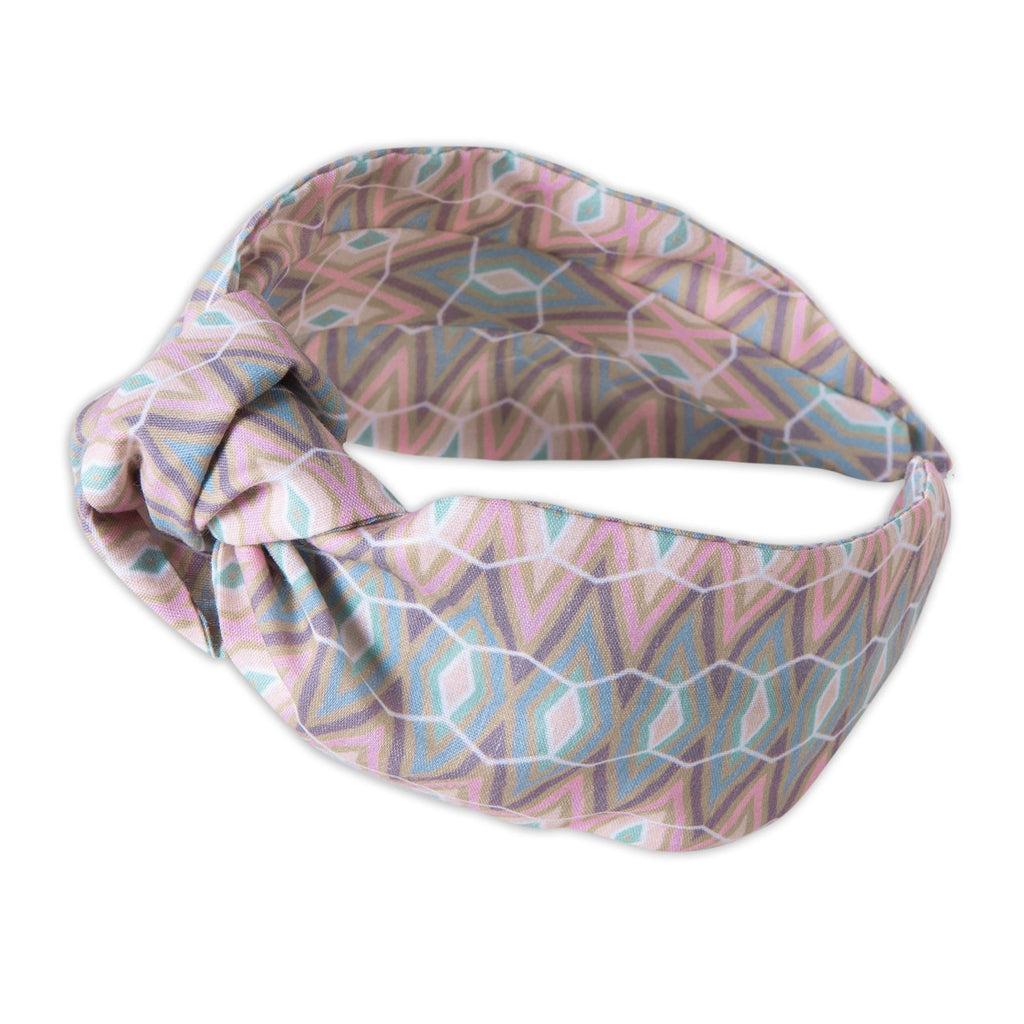 A Kate Whyley wide, knotted headband in subtle pastel hues, called Cool Stride