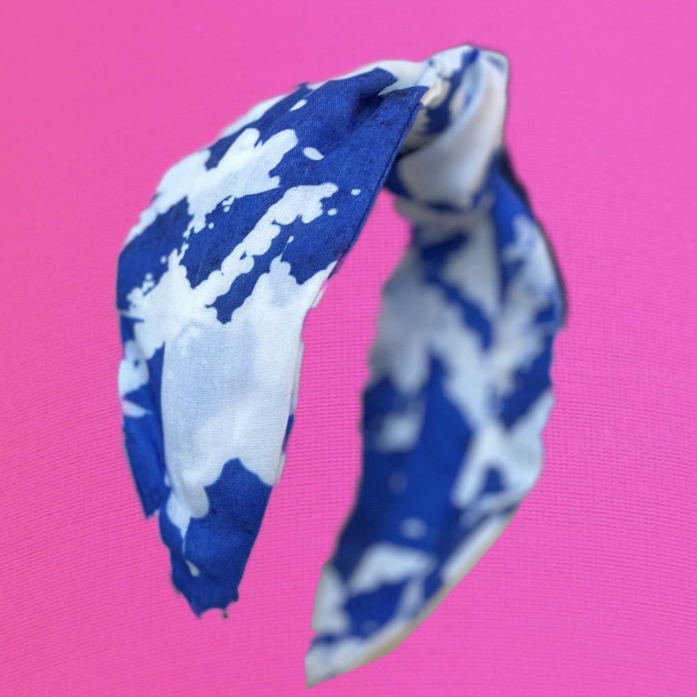 A Kate Whyley wide, knotted headband with a Yves Klein blue and white pattern, called Klein NY