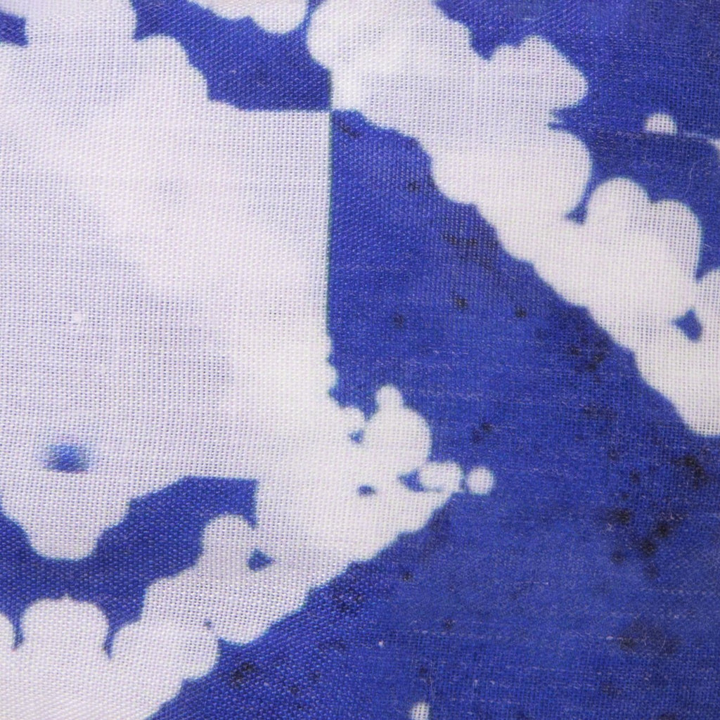 A close up image of Kate Whyley wide, knotted headband cotton fabric, with a Yves Klein blue and white pattern, called Klein NY