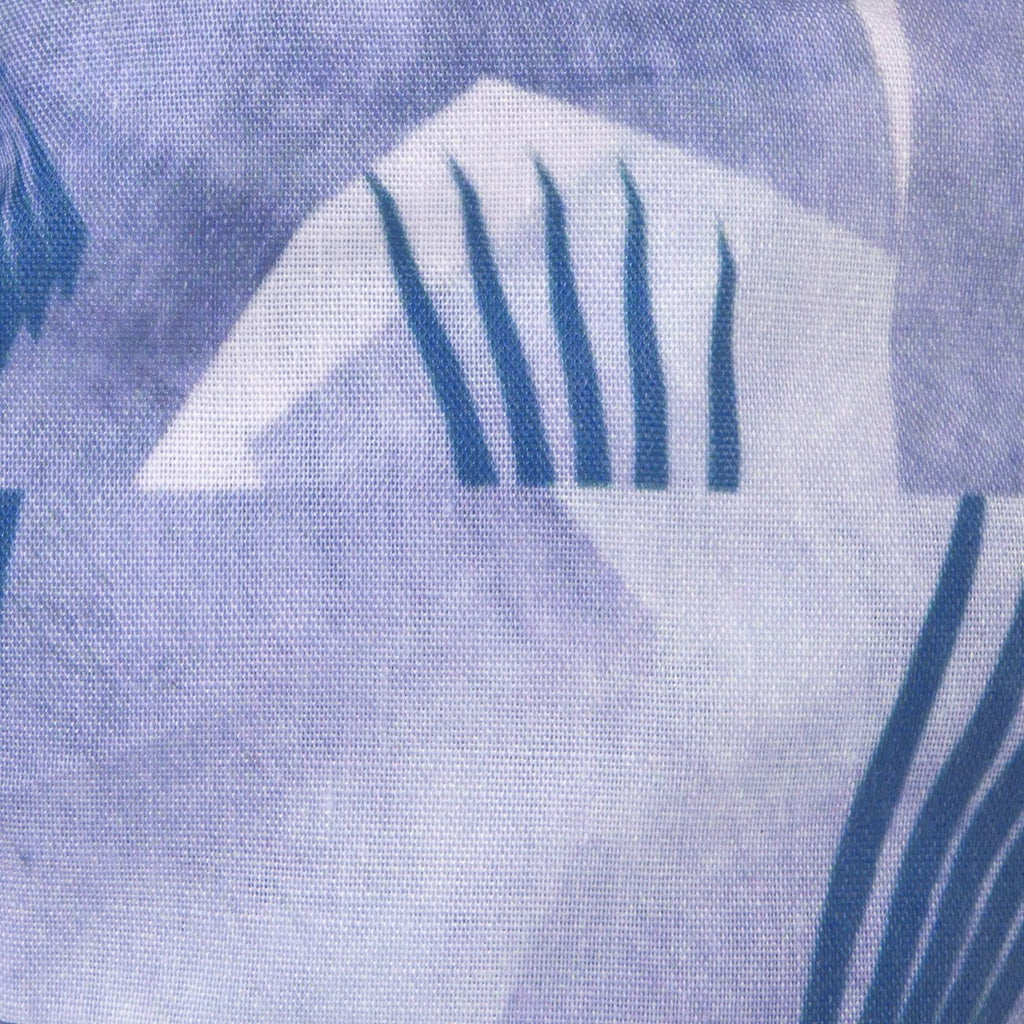 A close up image of Kate Whyley wide, knotted headband  cotton fabric, in blue hues, called Fan Flight