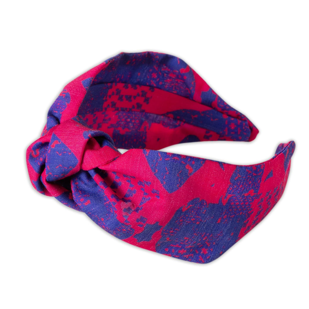 A Kate Whyley wide, knotted headband in cobalt blue and fuchsia pink design